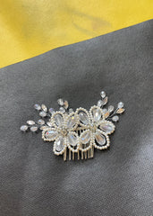 Decorative hair comb with crystals on a gray surface