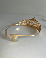 Gold tiara with comb on a white background