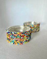 A set of multicolor beaded bangles with a silver metal frame, displayed in a 2x6 layout.