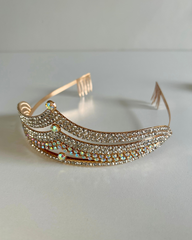 Decorative tiara on a reflective surface.