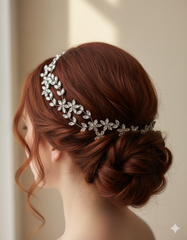 Woman with elegant hair styled in a bun wearing a decorative headband against a neutral background