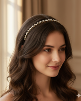 Woman wearing a pearl headband with a soft, blurred background