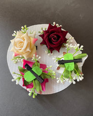 Decorative wreath with artificial flowers on a gray background