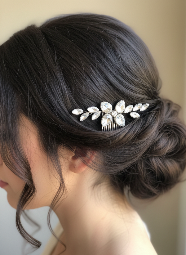 Close-up of a person with an elegant hairpiece featuring leaf-like designs.