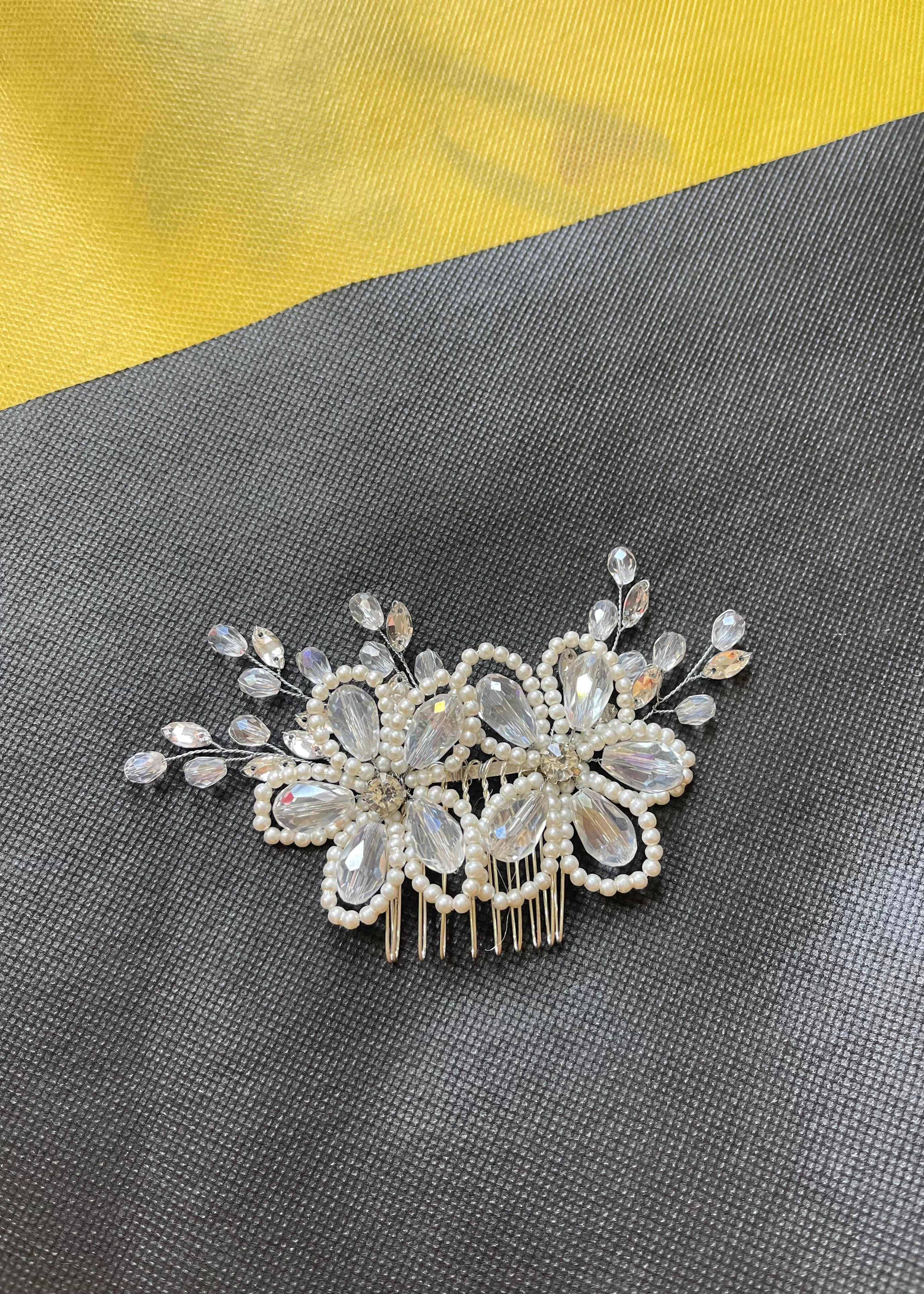 Decorative hair comb with crystals on a gray surface
