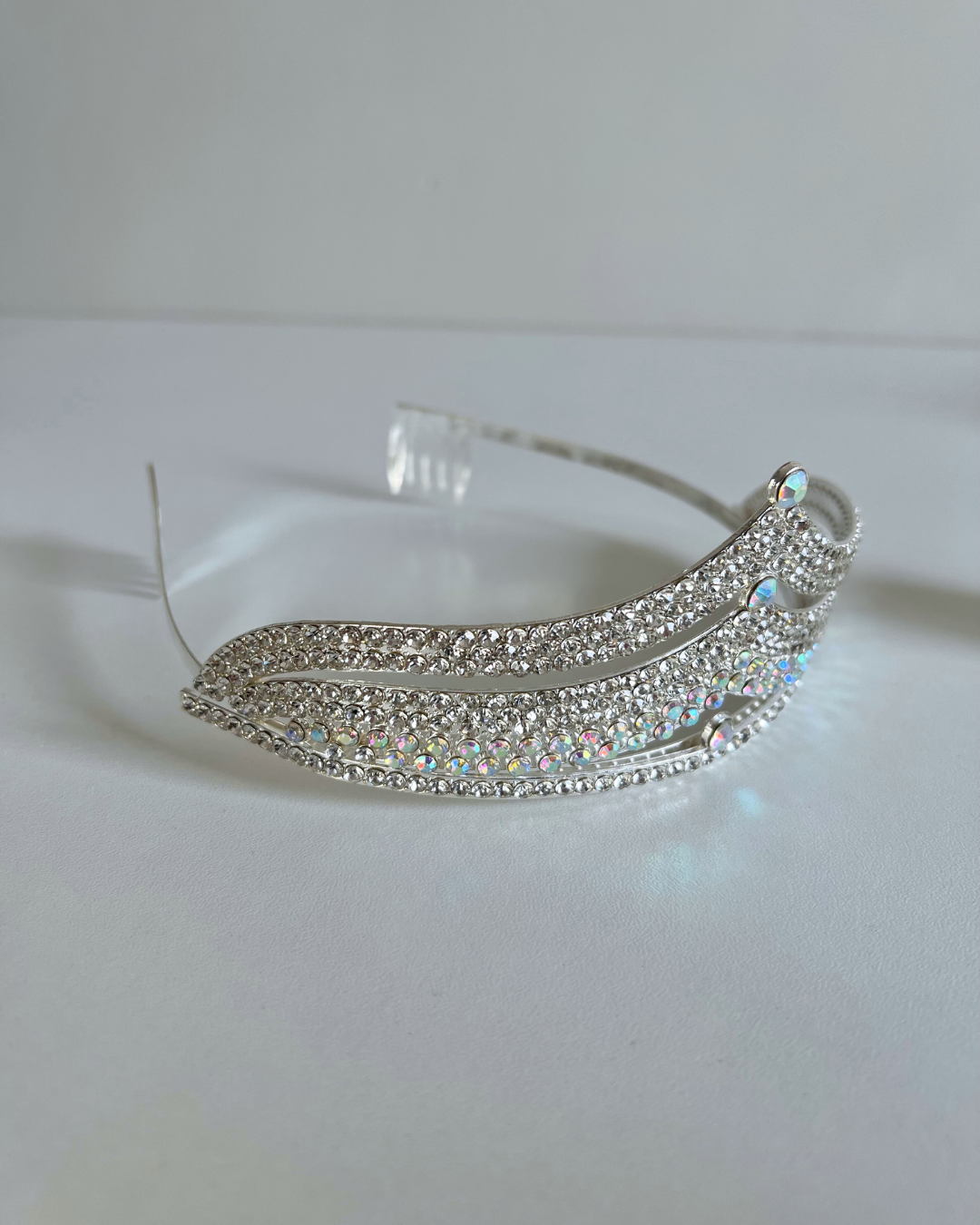 Silver tiara with gemstones on a white background