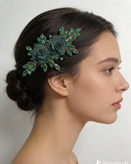 Woman with a decorative green hairpiece featuring flowers and leaves on a plain background