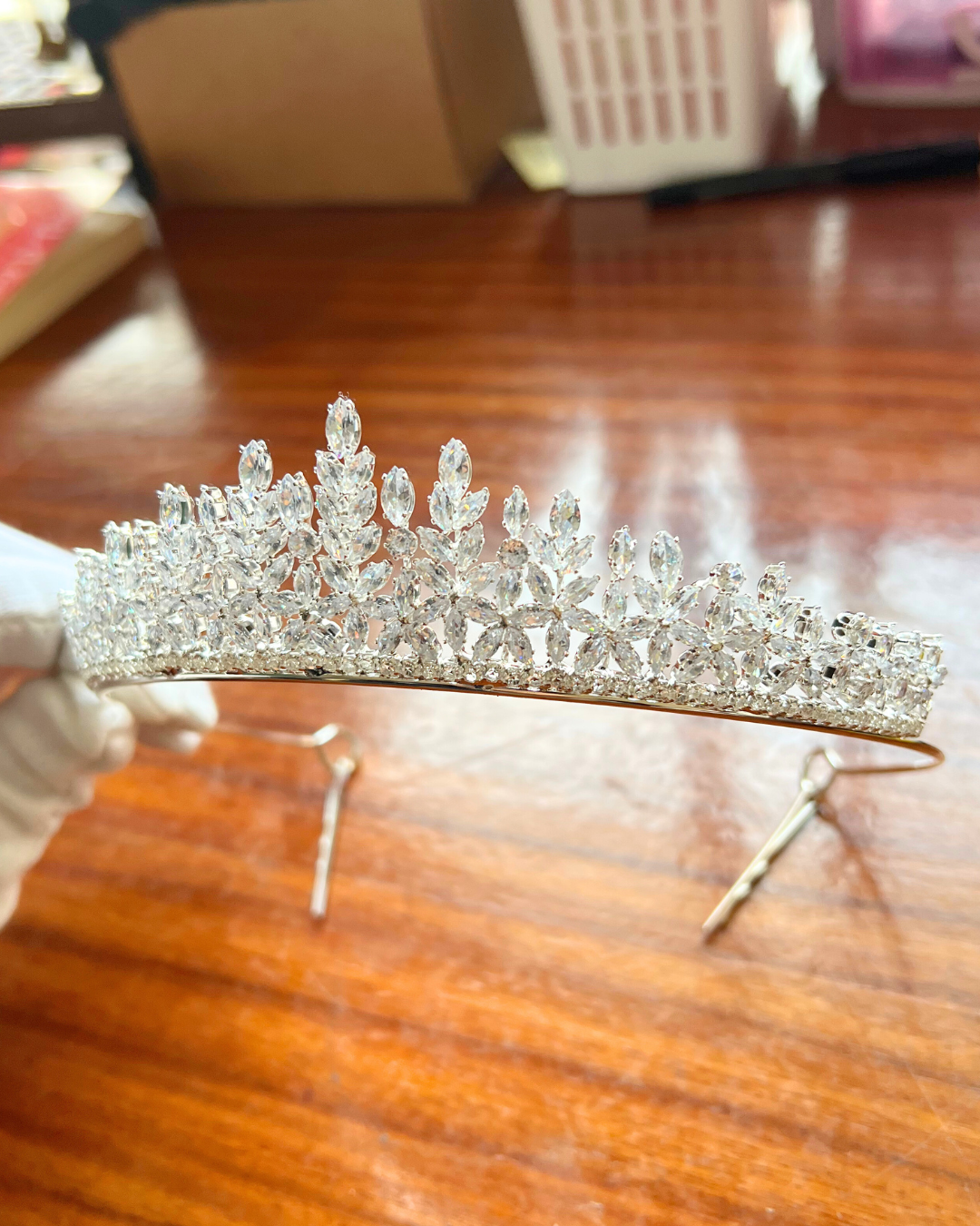 Silver tiara on a wooden surface
