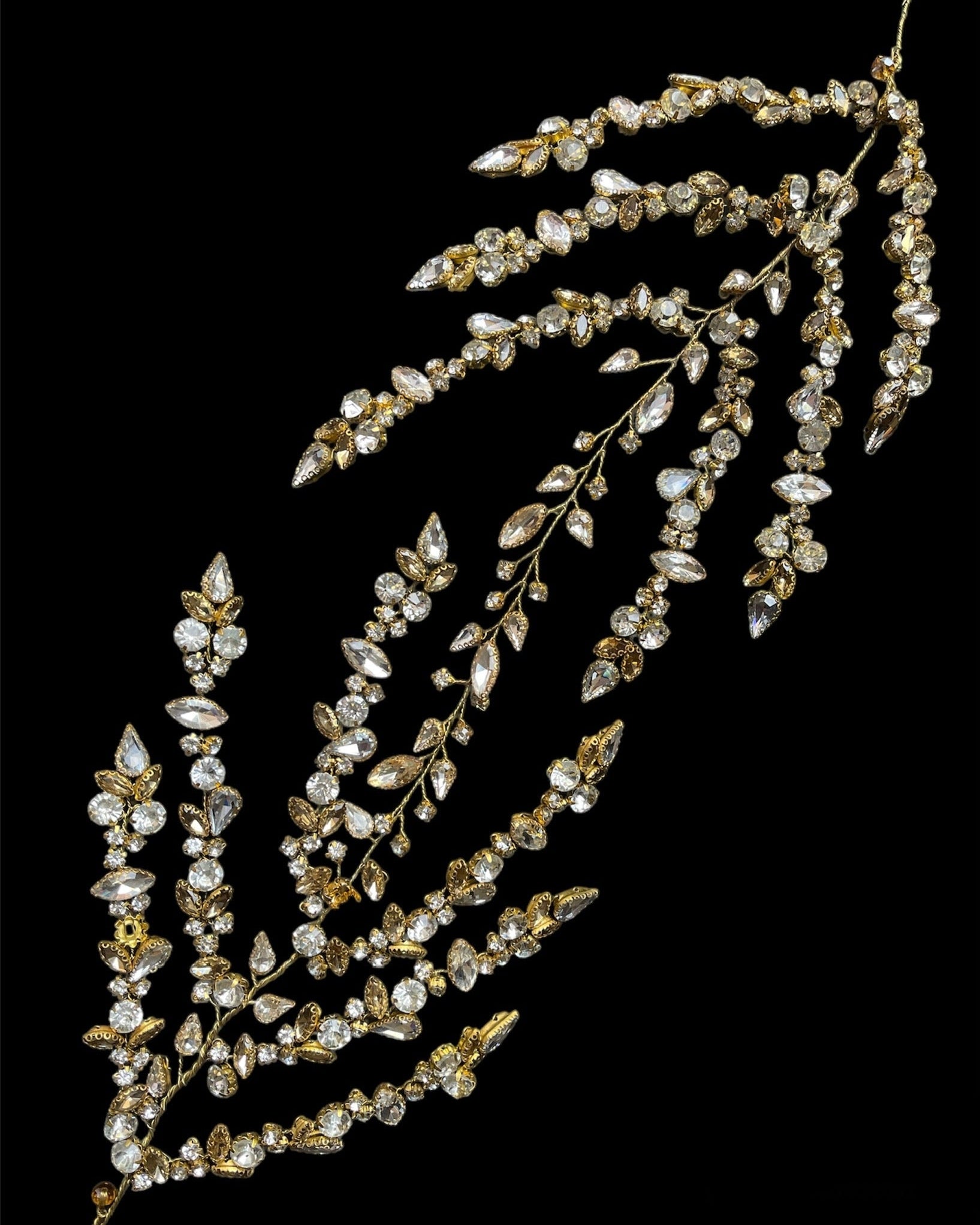 A delicate headpiece featuring silver crystals and rhinestones, arranged in a floral pattern.