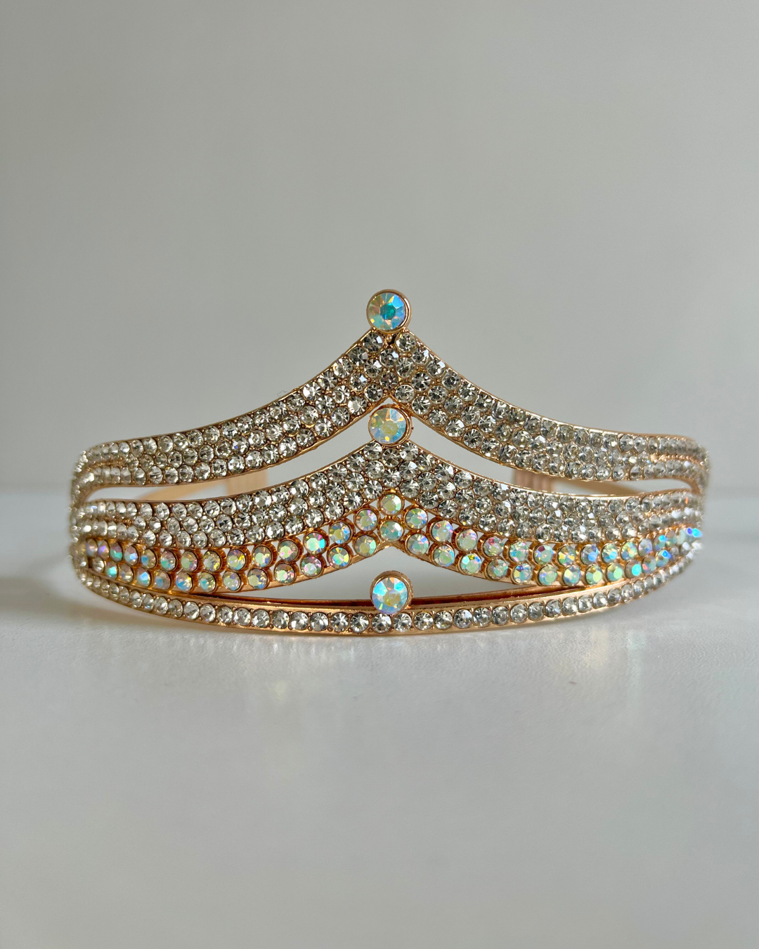 A sparkling tiara crown with available color options labeled as silver and gold.