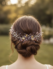 Woman with intricately styled hair adorned with decorative hairpiece outdoors